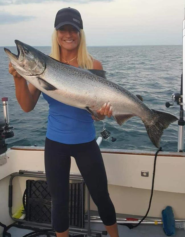 blonde woman posing with her big catch