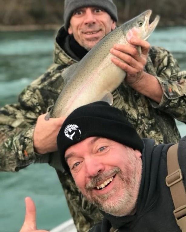 two happy men showing off what they caught
